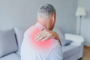 middle aged man suffering from shoulder pain