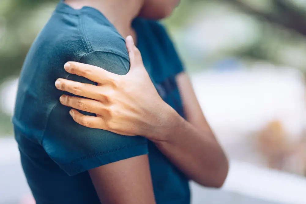 young woman with pain in shoulder