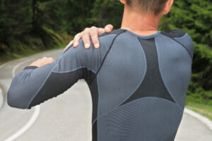 Man touching shoulder after exercising